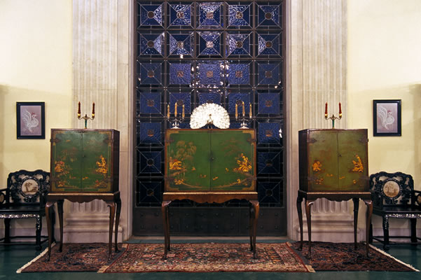 The cabinet containing the photograph of Bahá’u’lláh is to the left in the set. The other cabinets contain paintings of Bahá’u’lláh and the Báb. They are located in the Bahá'í International Archives.
