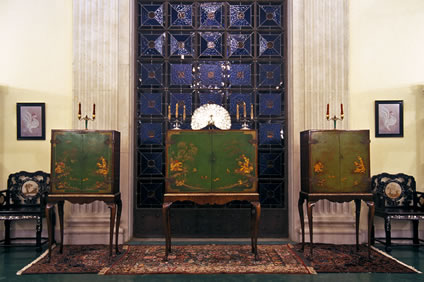 The cabinet containing the photograph of Bahá’u’lláh is to the left in the set. The other cabinets contain paintings of Bahá’u’lláh and the Báb. They are located in the Bahá'í International Archives.