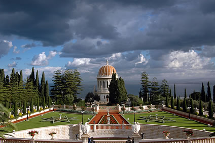 The completed Shrine of the Báb and gardens. The circle of cypress trees where Bahá’u’lláh stood can be seen on the right side of the Shrine.